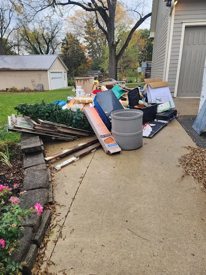 Dumpster being loaded with debris for 12 Yard Dumpster Rental in Atascadero